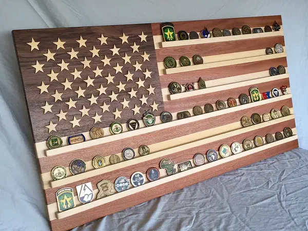 Finished wooden American flag with maple ledges displaying rows of challenge coins