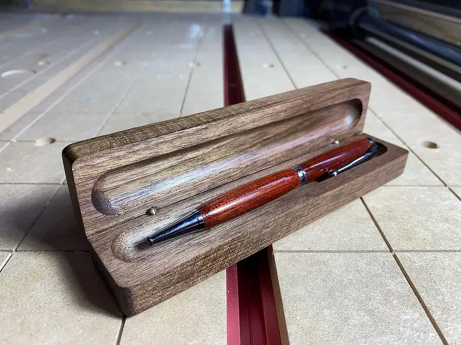 Finished wooden clamshell pen box open with two pens inside