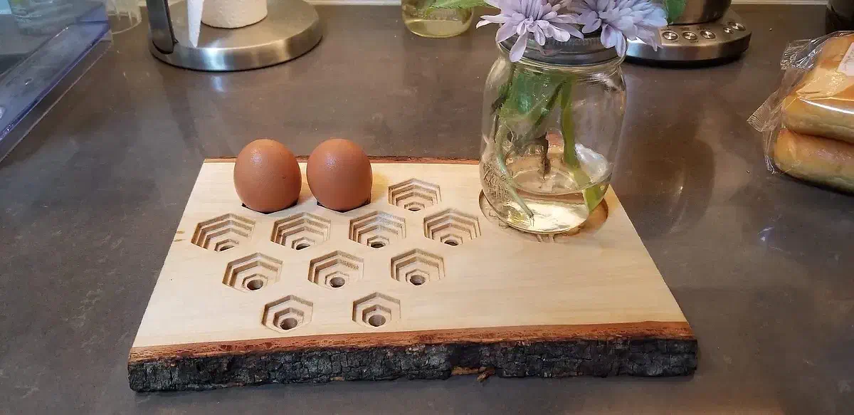 Eggs standing in a carved live-edge wooden tray